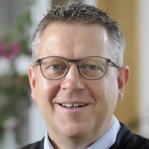 Photo of Grant Campbell. Grant has short hair and wears glasses.